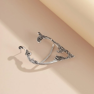 Detailed view of silver antique elf ear cuff with intricate vintage floral carvings