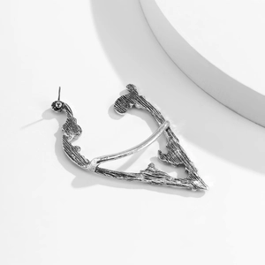 Detail of silver rose elf ear clip with vintage hollowed texture and dark gothic style
