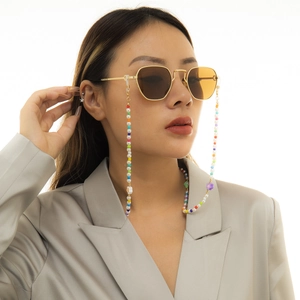 Star-beaded sunglasses chain with imitation pearls and colorful accents on orange glasses