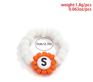 Detalle de anillo de cuentas coloridas con letra 'S', peso 1,8 g y tamaño 7 cm
