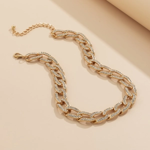 Detail van de gouden Cubaanse schakelketting met sprankelende strass en verstelbare sluiting