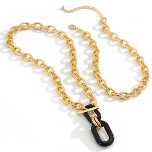 Close-up of golden link chain necklace with black and gold oval interlocking pendant