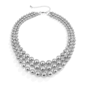 Detailed view of triple-layered silver bead necklace with lobster clasp and extender