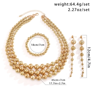 Detailed set of punk style large gold bead necklace, bracelet and tassel earrings