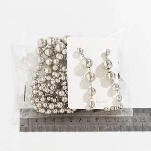 Silver punk style large bead necklace and dangling earrings set shown with a ruler for size