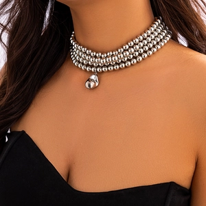 Close-up of four-layer silver beaded necklace with irregular metal pendant on model
