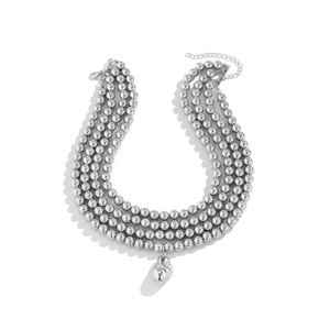 Detail of multi-layered silver beaded chain necklace with irregular water-drop pendant