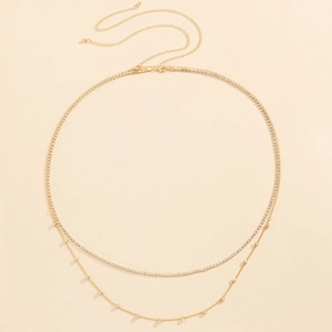 Detail of double-layer gold waist chain featuring rows of sparkling rhinestones