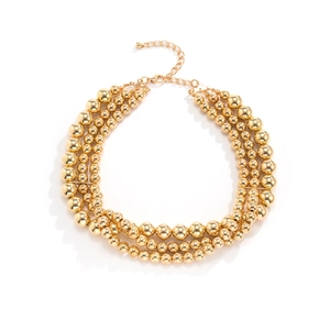 Detail of three-layer gold beaded punk necklace with adjustable chain and lobster clasp