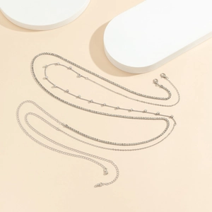 Detailed view of silver layered body chains with lobster clasp and extension links