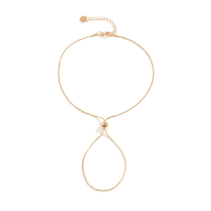 Close-up of golden snake chain anklet with adjustable bead and engraved Love tag