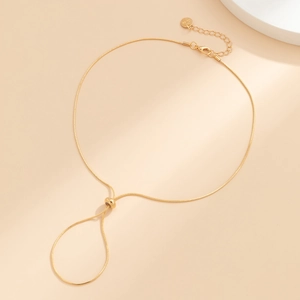 Detailed view of adjustable golden snake chain anklet with engraved Love heart charm