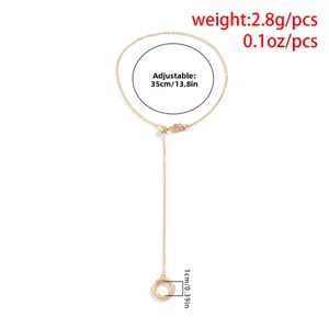 Detail of adjustable gold bead chain with lobster clasp and length measurement markers