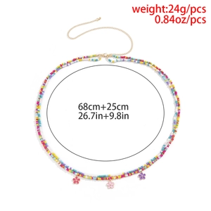 Detail of colorful beaded waist chain featuring floral charms and adjustable gold clasp