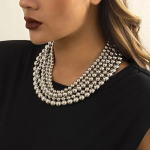 Close-up of layered silver bead chains with metallic luster on model neck