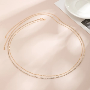 Detail of double-layer gold body chain with shimmering rhinestones and round metal sequins