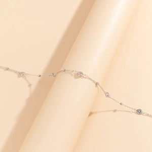 Detail of silver body chain with marquise and round crystals in a minimalist style