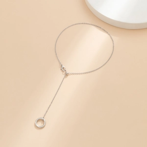 Detailed view of silver bead chain anklet with adjustable Y-shape and solid ring pendant