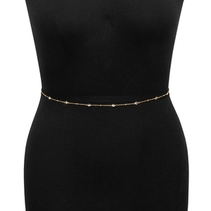 Detailed view of minimalist gold belly chain with sparkling crystals on black mannequin