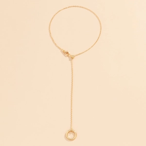 Detailed view of golden hand chain with bead accents and adjustable lobster clasp
