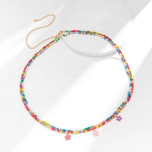 Detail of colorful seed bead waist chain with flower pendants and gold extender chain