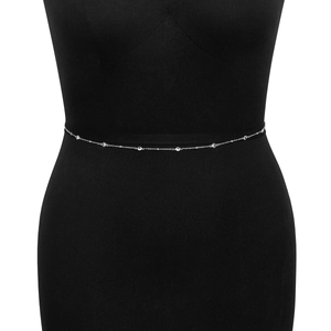 Close-up of a slim silver body chain with sparkling rhinestones on a black mannequin