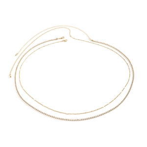 Detail of double-layer gold waist chain with shimmering rhinestones and metal discs