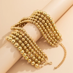 Detail of layered gold beaded punk necklace with adjustable lobster clasp and chain