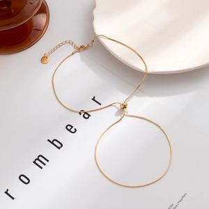 Minimalist adjustable gold snake chain necklace with Love tag on white magazine