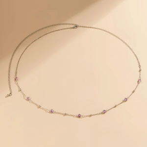 Detail of silver body chain featuring pink round crystals and adjustable lobster clasp