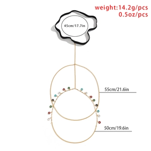 Detail of gold thigh chain with colorful small ring charms and elastic band measurements
