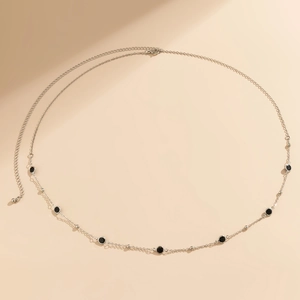 Detail of silver body chain with black circular beads and adjustable lobster clasp