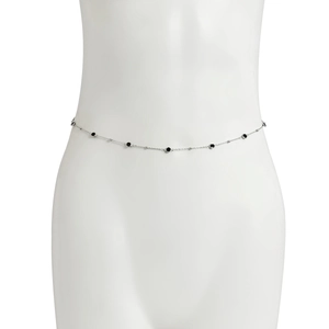 Close-up of silver body chain with black bead accents on a white mannequin