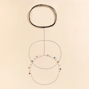 Detail of layered silver body chain with colorful beads and star rhinestone pendants