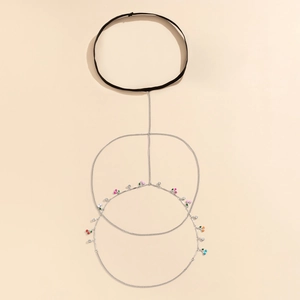 Detail of silver body chain with colorful cherry pendants and black elastic choker
