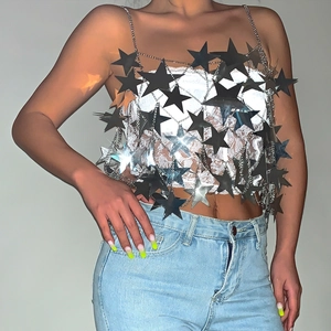 Macro detail of silver star sequin metal chain vest for festive party outfits