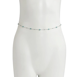 Detailed close-up of silver chain waist belt featuring round blue crystal inlays