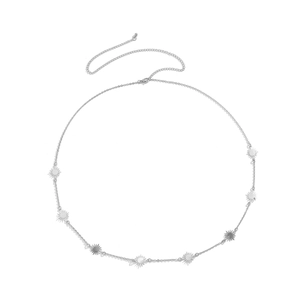 Macro detail of silver link body chain with starburst charms and mirror finish