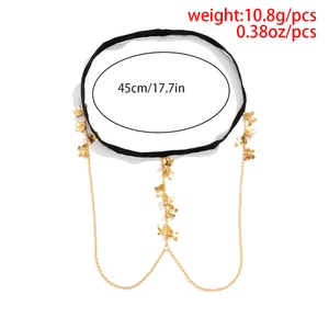 Detailed view of elastic leg chain with golden butterfly charms and rhinestone tassels