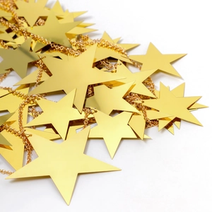 Detailed macro view of glossy gold star sequins and shiny metallic chain links