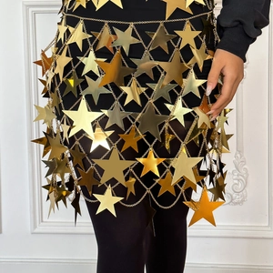 Macro view of gold star sequins body chain with fringe and hollow out metallic design