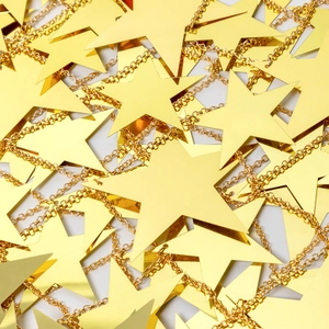 Detailed macro view of gold star sequins and shiny metallic body chain for party wear