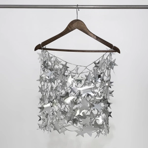 Close-up of silver sequin star body chain featuring hollow mesh design for festivals