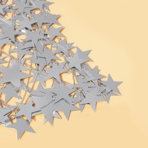 Close-up of shiny silver star sequins on a metal body chain with reflective finish