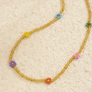 Detailed close-up of handmade colorful seed bead daisy flower waist chain jewelry