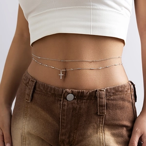 Detailed close-up of double-layered silver waist chain with rhinestone cross pendant
