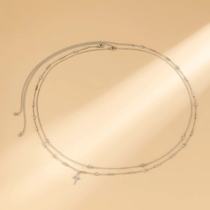 Detail of double-layer silver body chain with crystal cross pendant and adjustable link