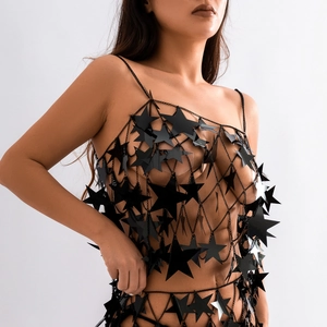 Macro shot of fashion body chain featuring black star-shaped sequins and metal fringes
