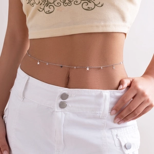 Détail d'une chaîne de taille argentée avec étoiles et cristaux sur mannequin