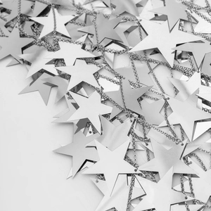 Close-up of silver star-shaped metal sequins and fringe body chain for nightclub wear